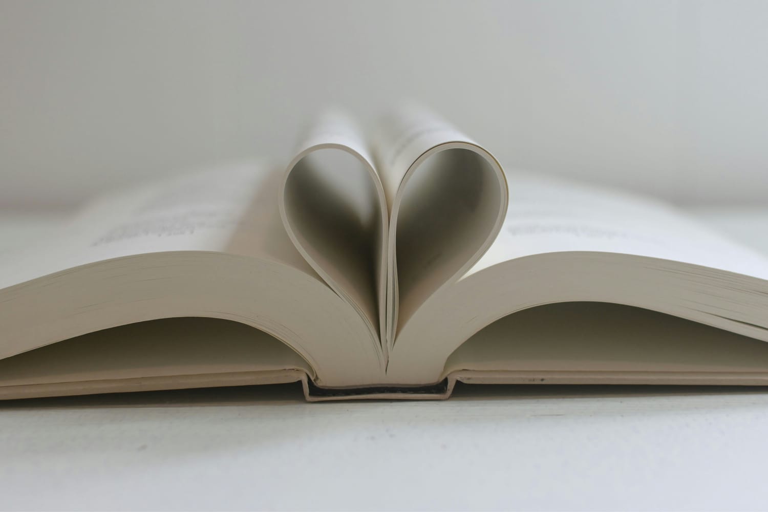 Open book with heart-shaped pages